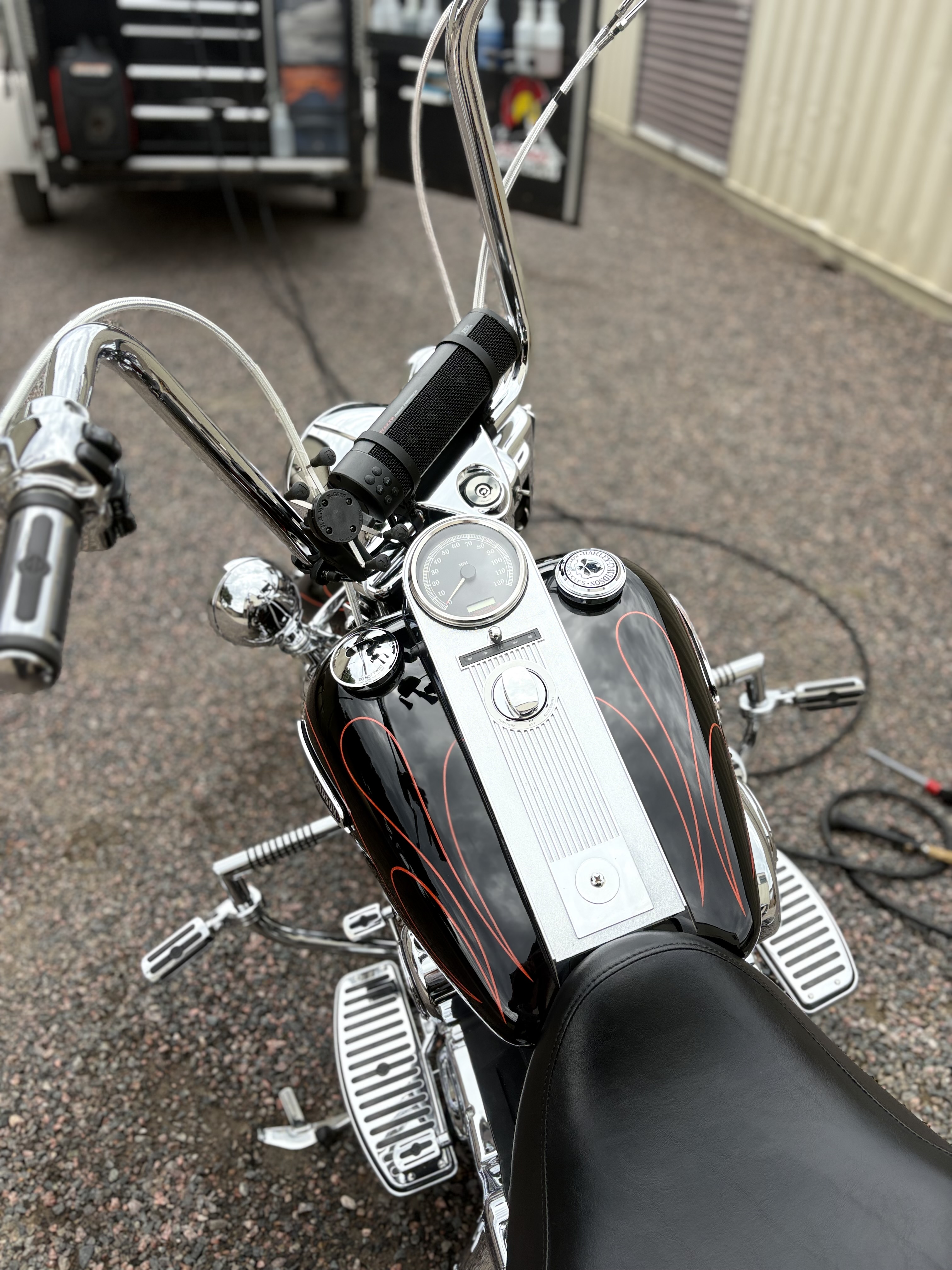 Harley-Davidson fuel tank with orange pinstriping and chrome